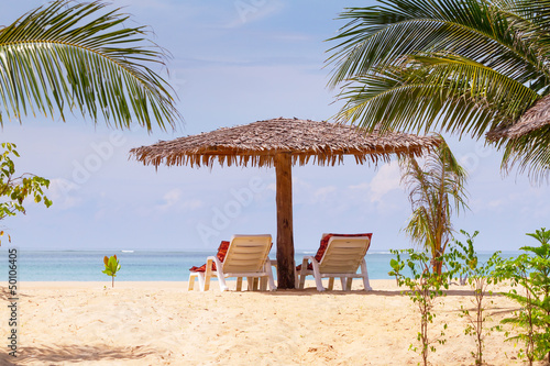 Fototapeta Naklejka Na Ścianę i Meble -  Tropical beach scenery with parasol and deck chairs in Thailand