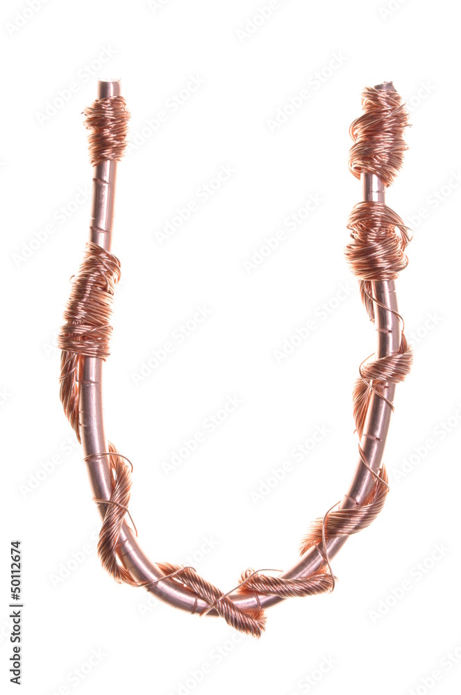 Fototapeta premium Twisted copper wire in the shape of the letter U