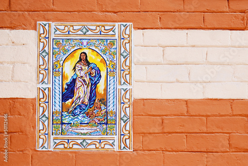 Virgen María en azulejos de cerámica  sobre  pared pintadaa