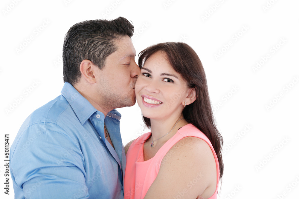 Close-up portrait of woman being affectionately kissed by her hu Close-up portrait of woman being affectionately kissed by her hu