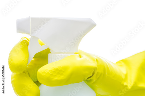 Hand in a yellow glove holding a spray