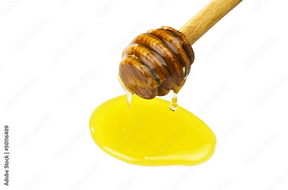 Honey dripping from a wooden of olives dipper Honey dripping from a wooden of olives dipper