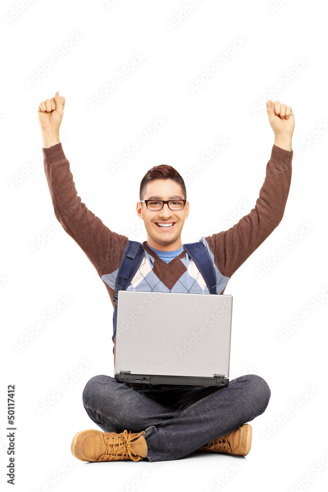 Happy male student sitting with a laptop and gesturing happiness Happy male student sitting with a laptop and gesturing happiness