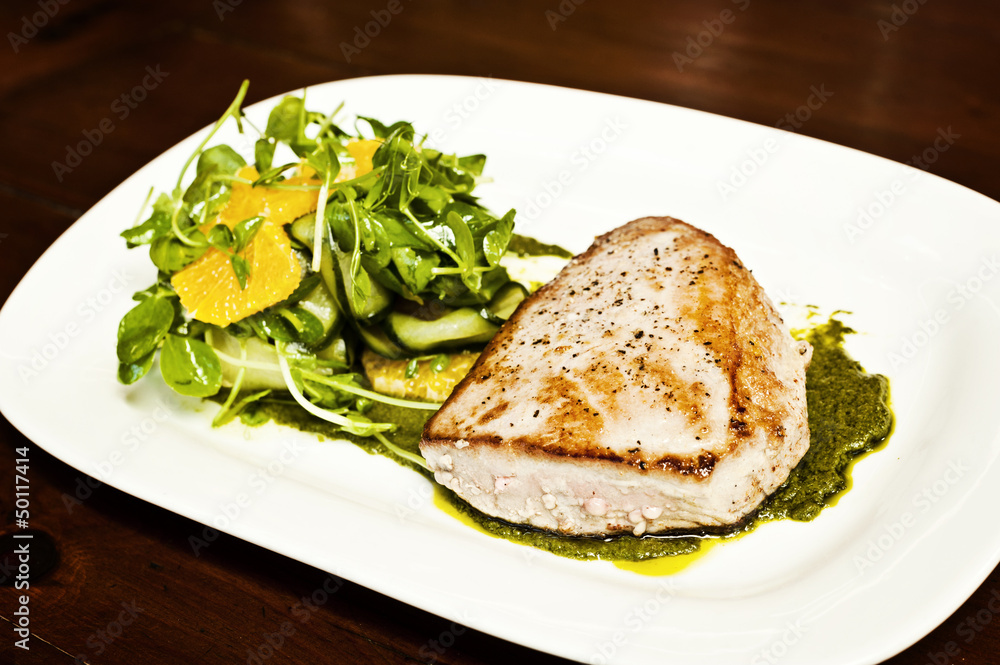 grilled fish on a white plate. grilled fish on a white plate.