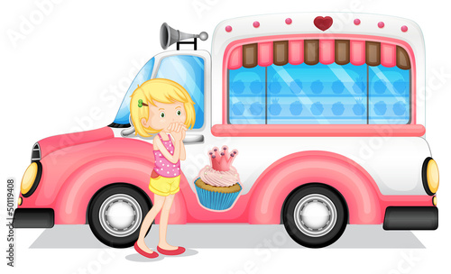 A young girl beside the pink bus