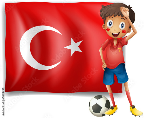 A soccer player in front of a Turkish flag