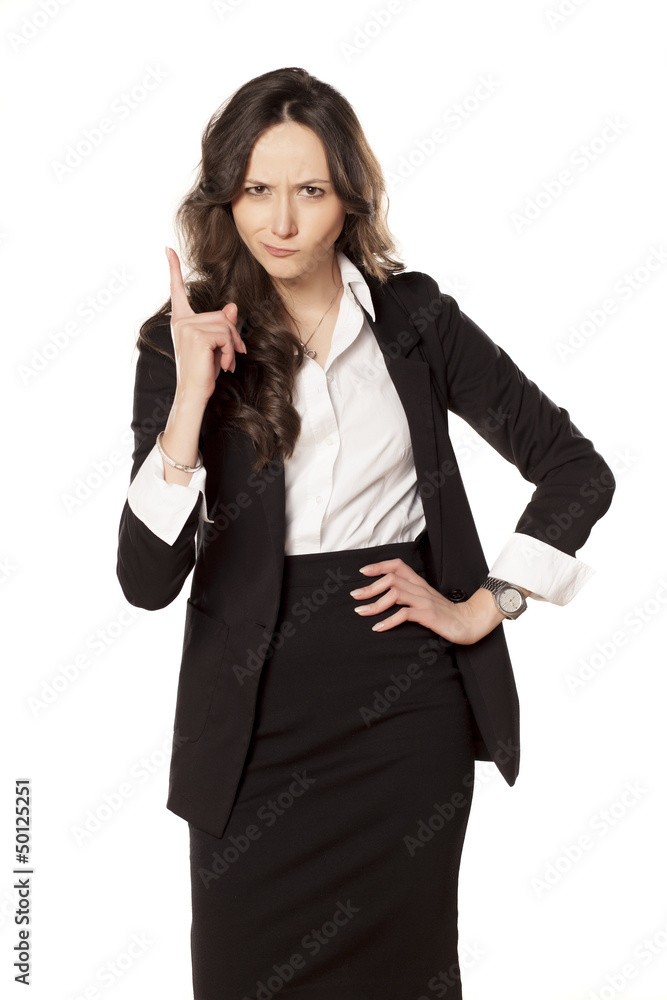 frowning and angry business woman pointing a finger upwards frowning and angry business woman pointing a finger upwards