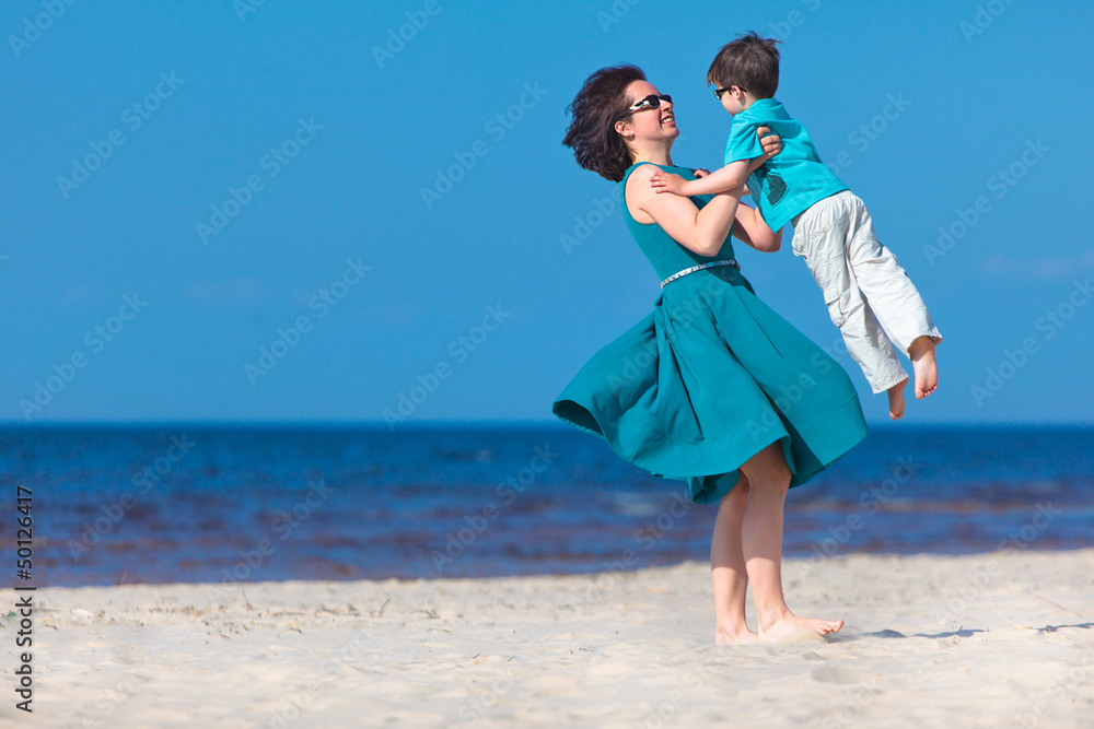Mother and her little son enjoying beach Mother and her little son enjoying beach