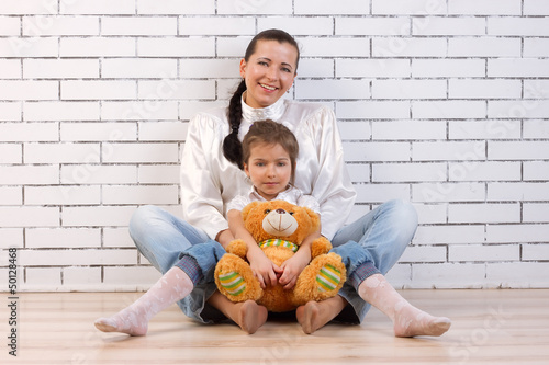 Mother, daughter and soft toy
