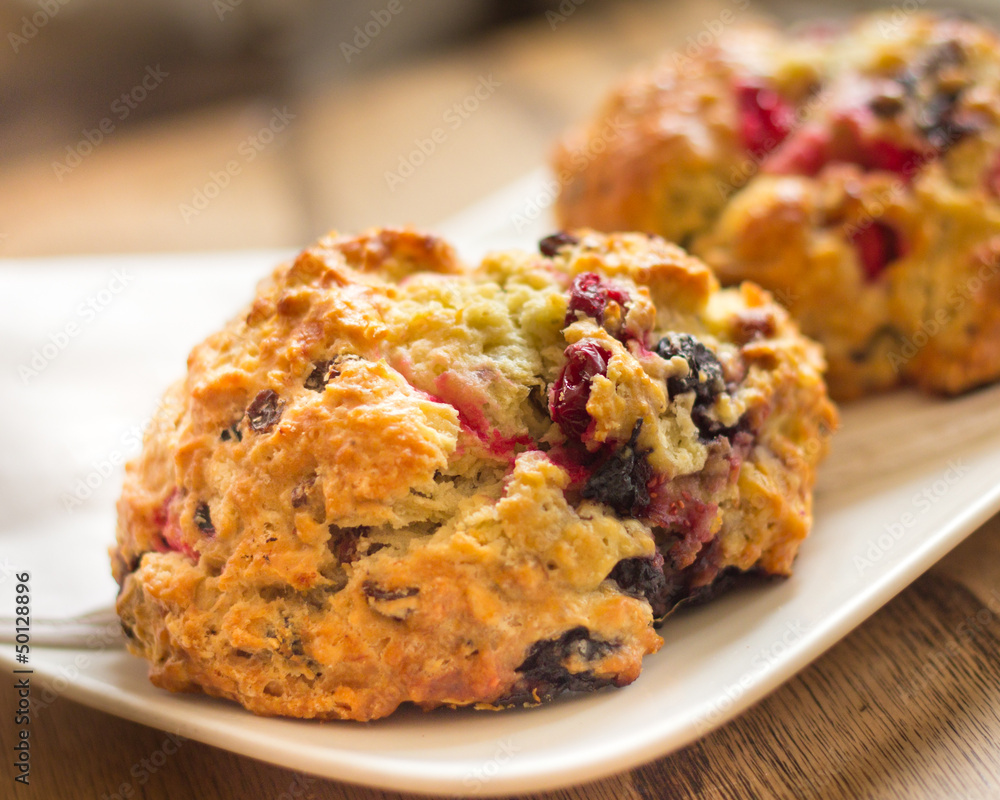 Warm cranberry scones on plate