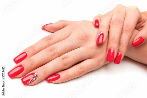 Beautiful female hands  with red nails isolated on white
