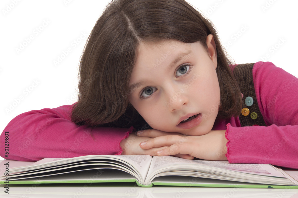 Beautiful little girl reading a book