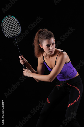 woman with badminton racket isolated on black © zhagunov_a