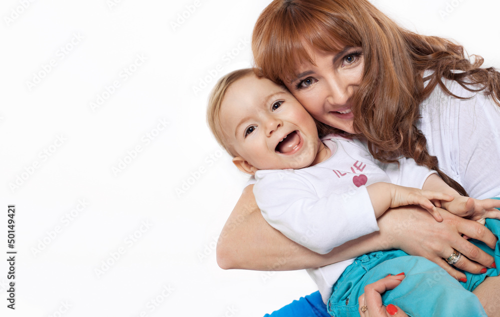 Beautiful smiling mum hugging her child isolated on white Beautiful smiling mum hugging her child isolated on white
