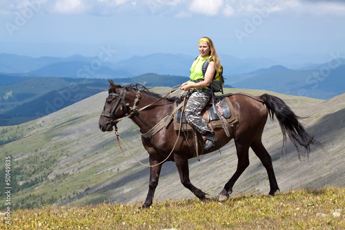  rider with backpack on horseback © JackF