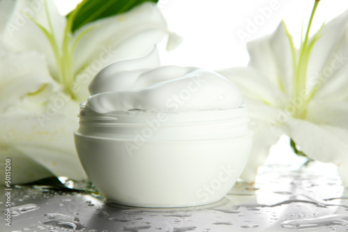 Fototapeta Naklejka Na Ścianę i Meble -  Cosmetic cream and beautiful lily, close up