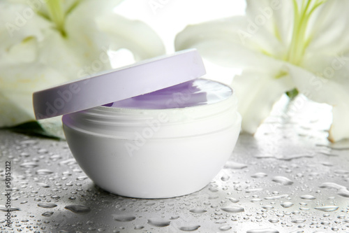 Fototapeta Naklejka Na Ścianę i Meble -  Cosmetic cream and beautiful lily, close up