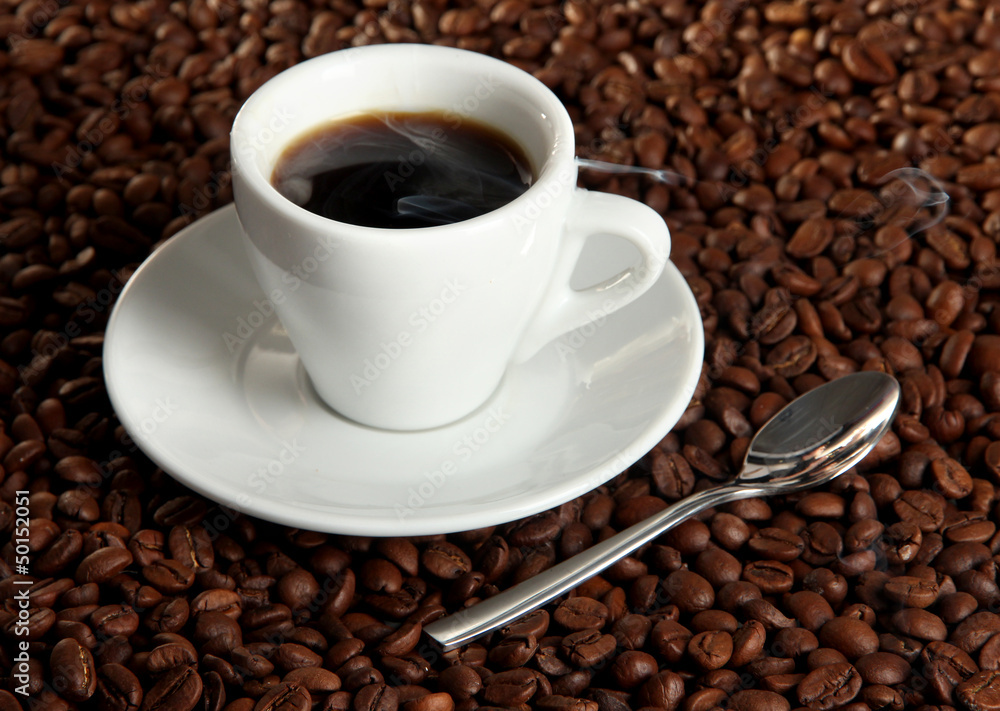 Cup of coffee on coffee beans background Cup of coffee on coffee beans background