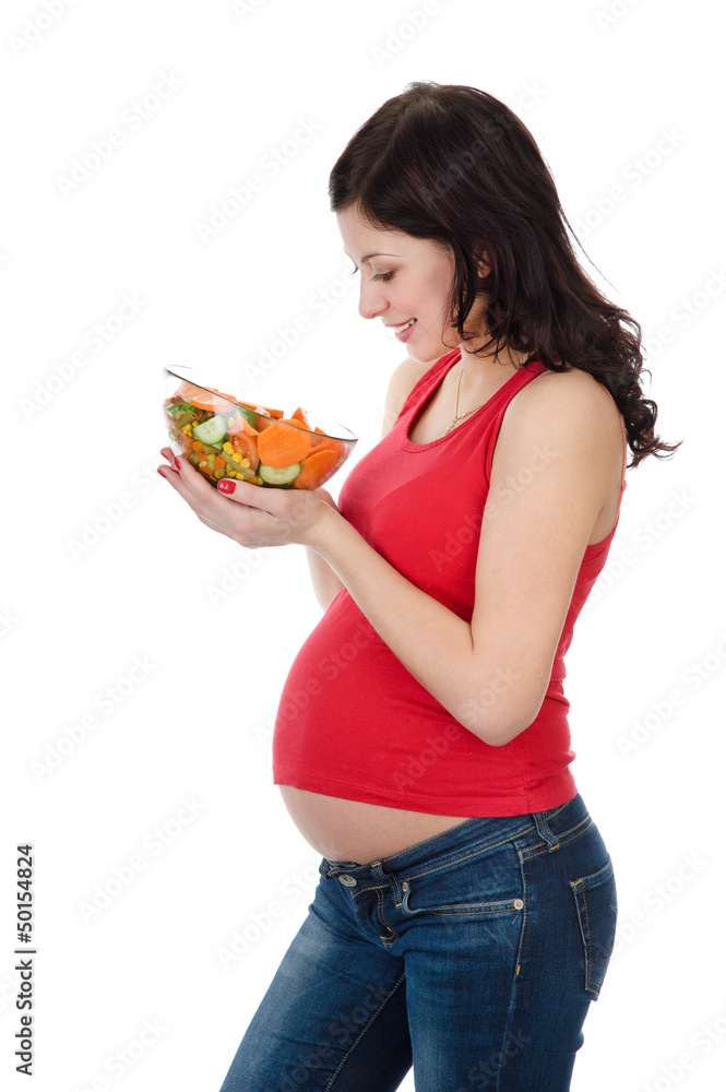 beautiful pregnant woman eating salad. isolated on white