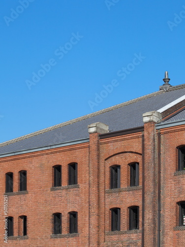A photograph of a red brick building in Yokohama