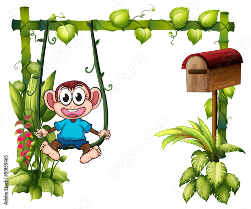 A monkey swinging beside a wooden mailbox
