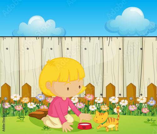 A girl feeding the cat inside the fence