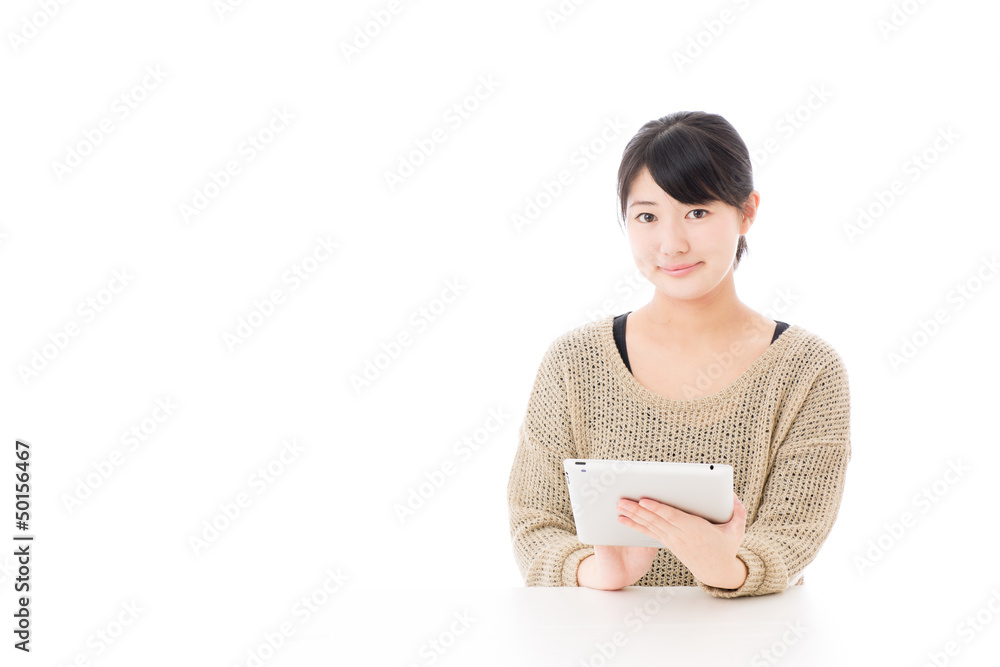 a young asian woman using tablet computer a young asian woman using tablet computer