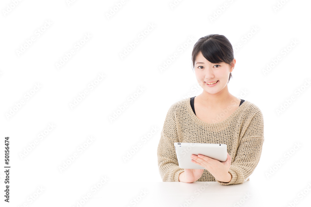 a young asian woman using tablet computer a young asian woman using tablet computer