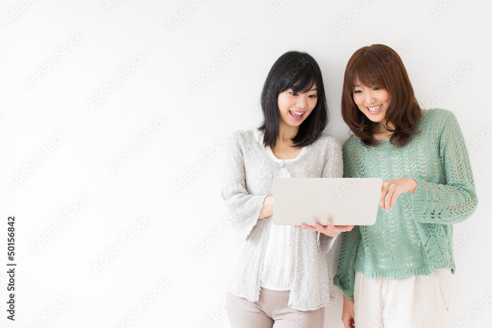 attractive asian women using laptop in the room attractive asian women using laptop in the room