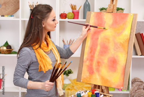 beautiful young woman painter at work, photo