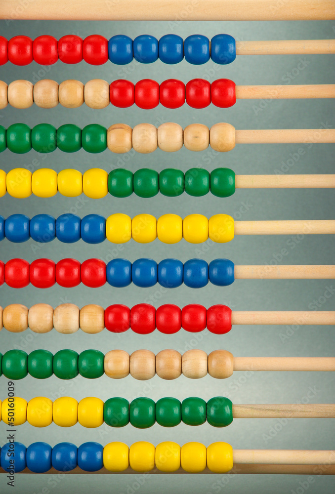 Bright wooden toy abacus, on grey background Bright wooden toy abacus, on grey background