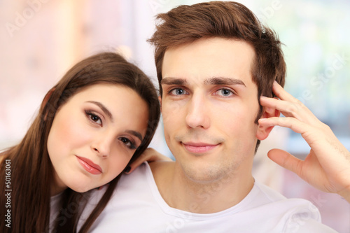 Young couple on bright background