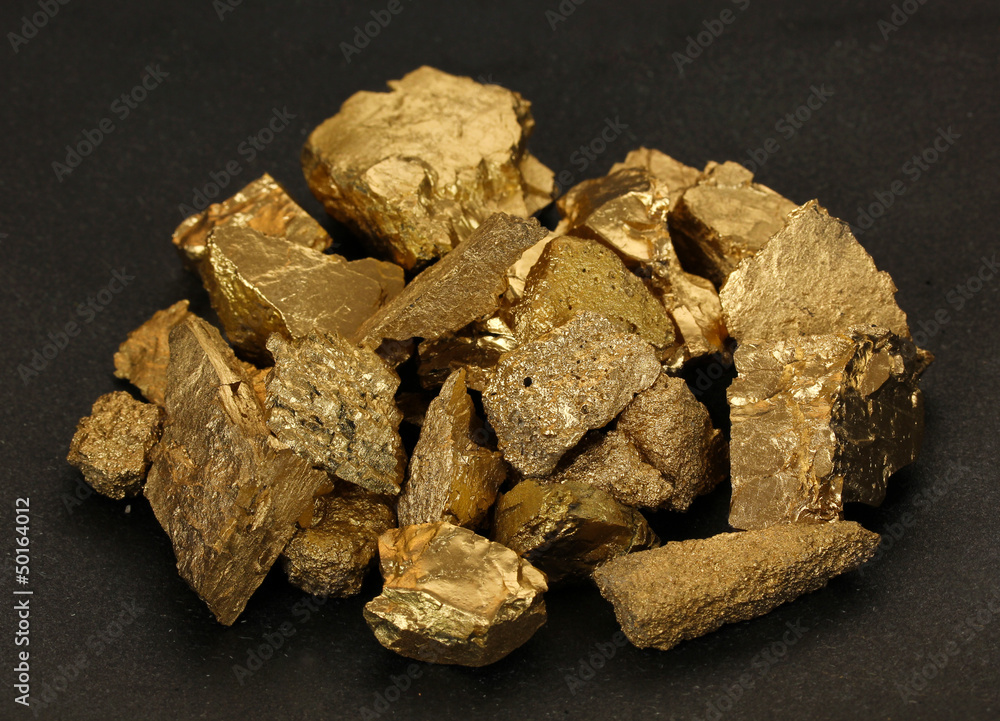 Golden nuggets on black background Golden nuggets on black background