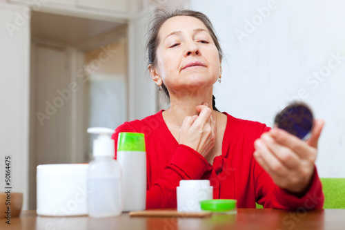 Mature woman stares on neck photo