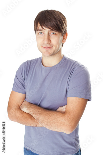 smiling man standing with hands folded against isolated on white © GVS