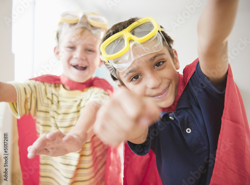 Boys dressed in capes as superheroes photo