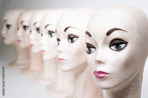 Group of bald, female mannequin heads photo