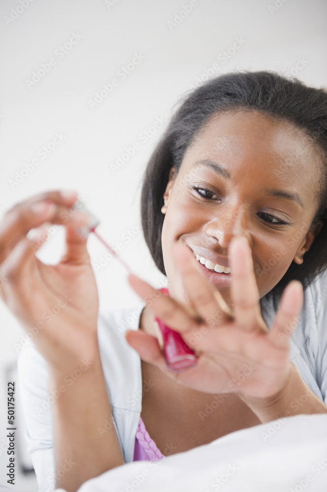 Black woman painting her fingernails Black woman painting her fingernails