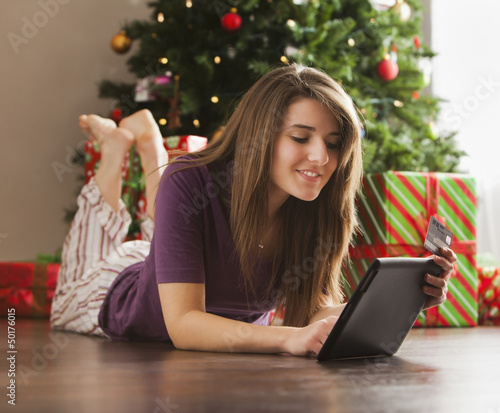 Caucasian woman using digital tablet at Christmas time photo