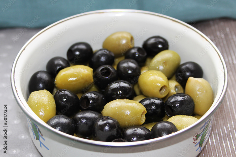 Closeup picture of green and black olives in white bowl Closeup picture of green and black olives in white bowl