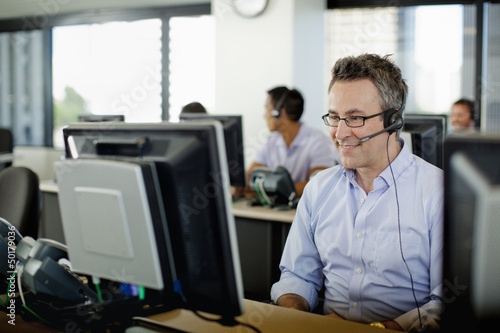 Business people working on computers in call center