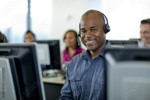 Business people working on computers in call center photo