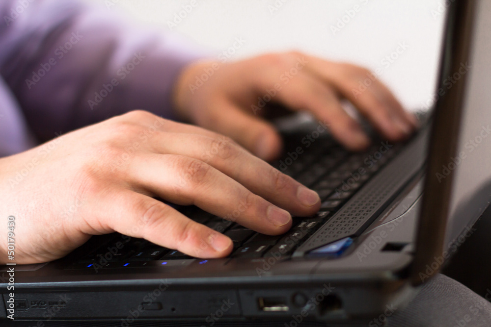 Businessman holding a laptop and is working on it Businessman holding a laptop and is working on it