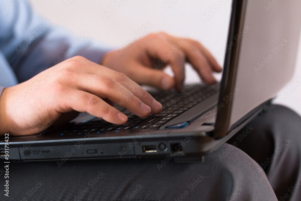 Businessman holding a laptop and is working on it Businessman holding a laptop and is working on it