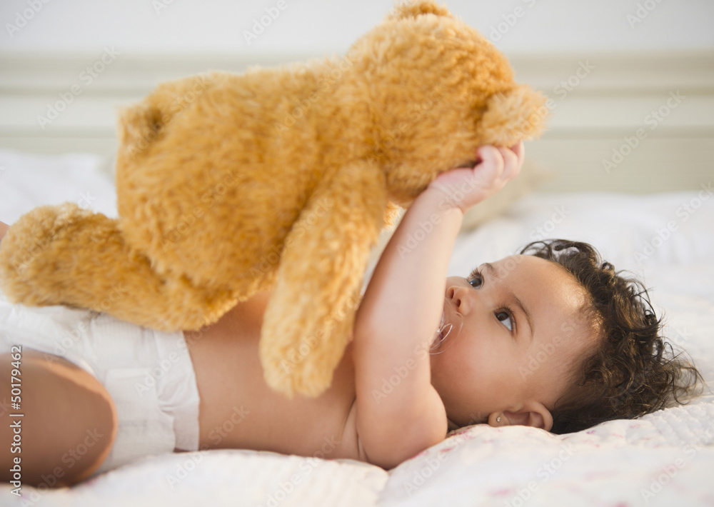Mixed race baby holding teddy bear Mixed race baby holding teddy bear