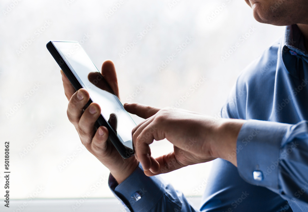 A man holding a tablet pc A man holding a tablet pc