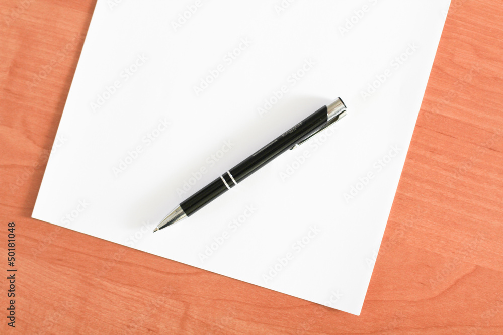 Blank sheet of paper and a pen on the table Blank sheet of paper and a pen on the table