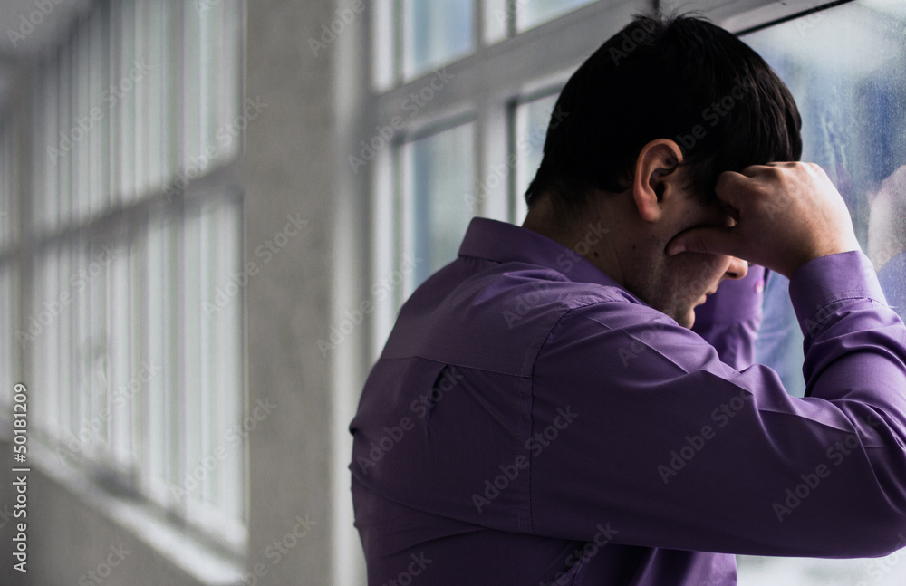 A man holds his head, hi have big problems, stress A man holds his head, hi have big problems, stress