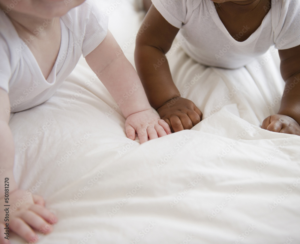 Babies laying on floor together Babies laying on floor together