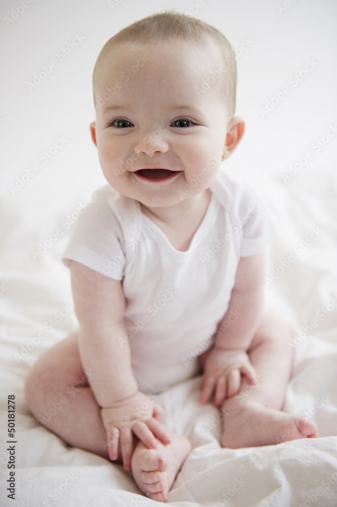 Caucasian baby girl sitting on floor Caucasian baby girl sitting on floor
